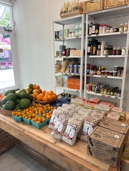 pexels-photo-31858793-31858793 A variety of fresh fruits and organic products in a sunny grocery store setting.
